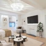 Spacious living room with a large TV, cozy seating, and modern decor.