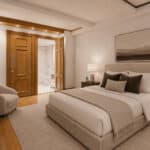 Elegant bedroom with king-sized bed, modern art, and warm lighting.