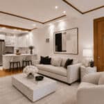 Spacious living room with white sofa, marble coffee table, and open kitchen area.